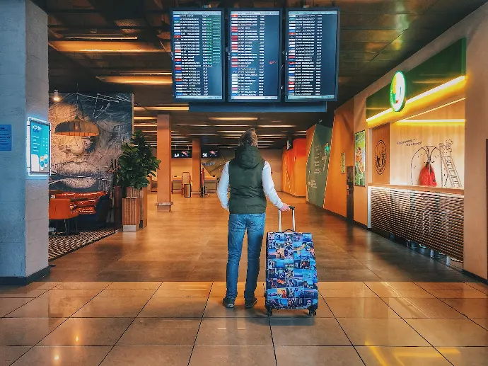 person standing with holding luggage bag